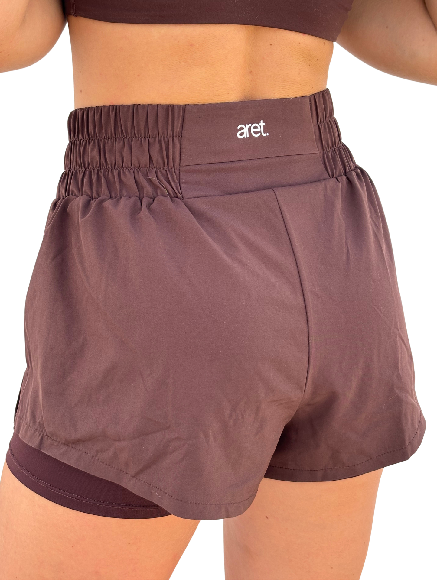 Short para mujer con bolsillo para running en marrón
